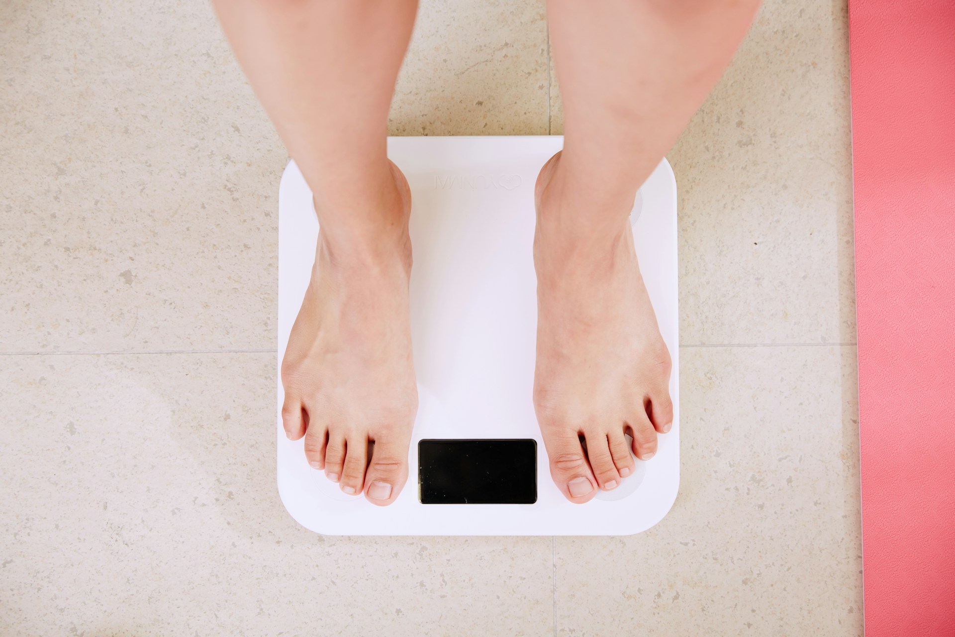 lose weight-person checking his weight on digital scale